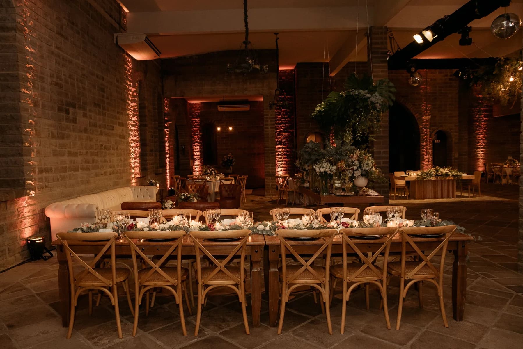 Warm event room prepared for dinner, music, and photography