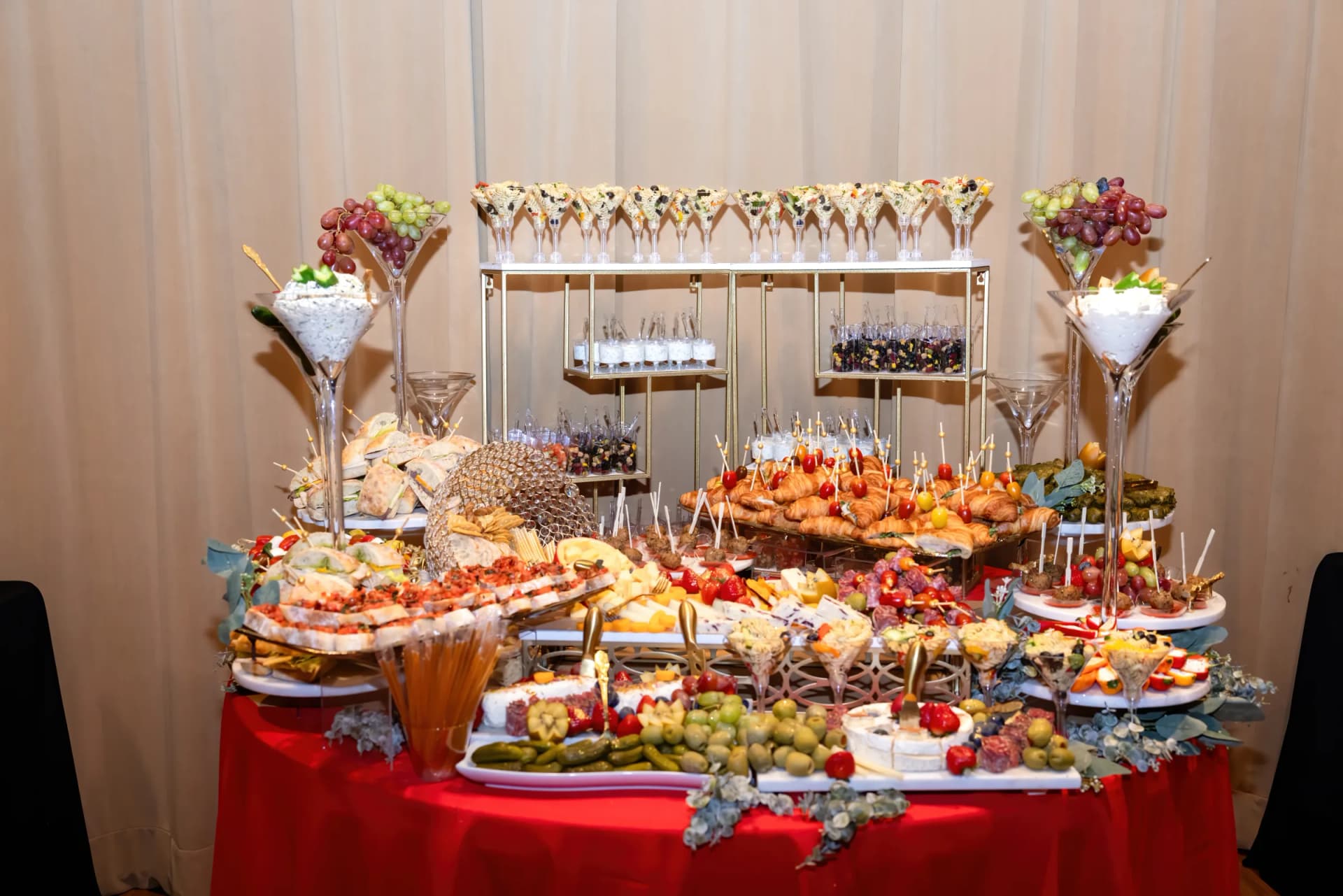 Full L’Amore grazing and appetizer table with sandwiches, cheese, fruit, and savory bites
