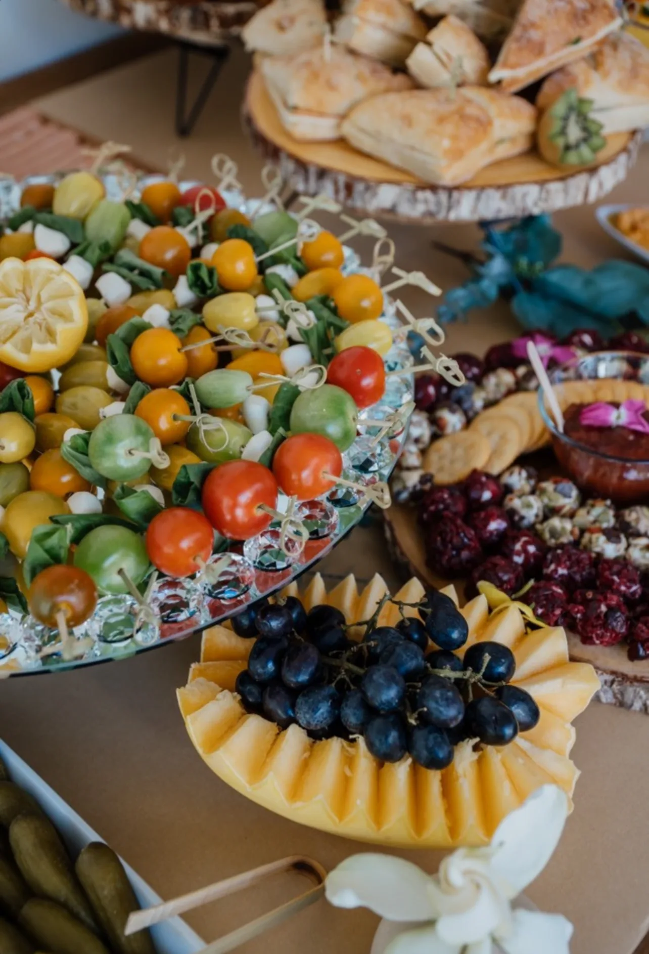 L’Amore grazing table with fruit, cheeses, tomatoes, and charcuterie