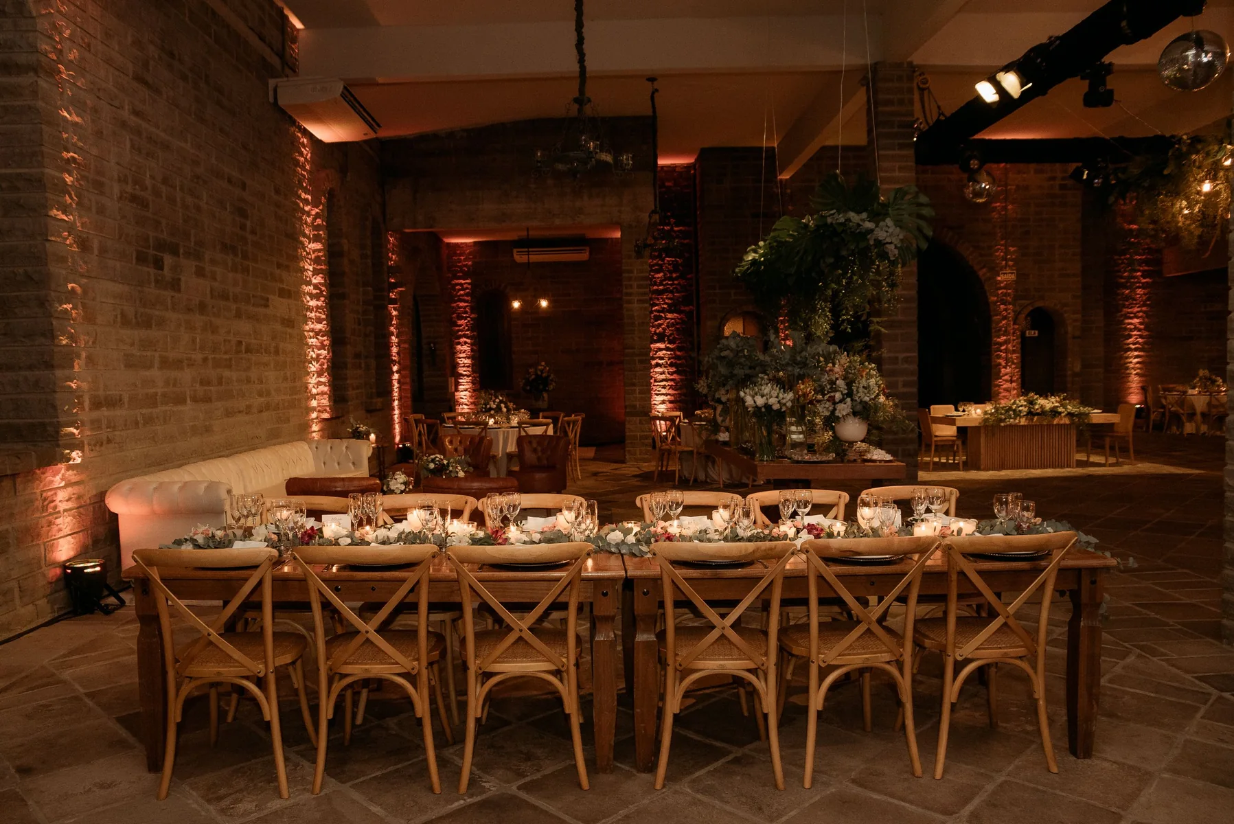 Warm event room prepared for dinner, music, and photography
