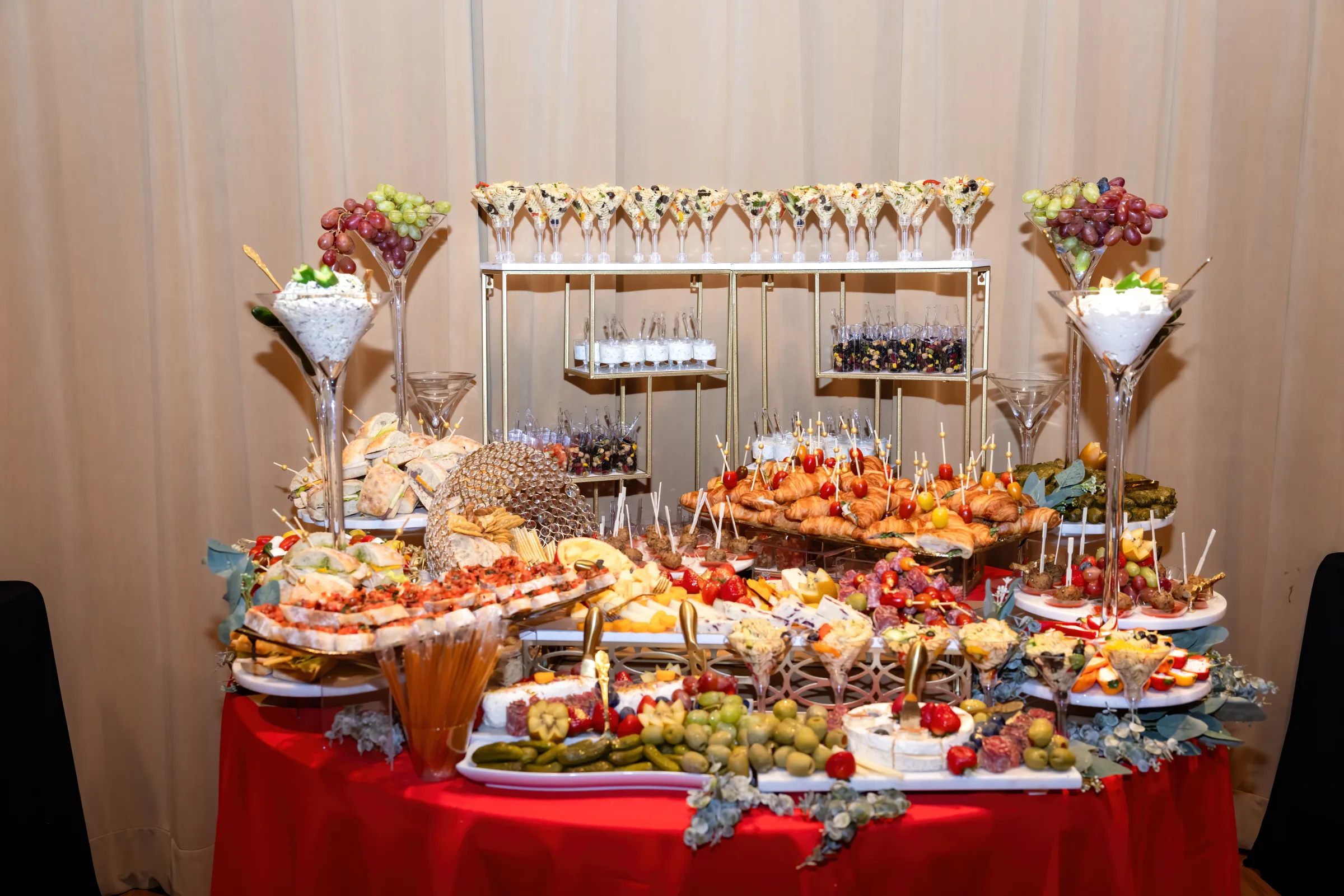 Full L’Amore grazing and appetizer table with sandwiches, cheese, fruit, and savory bites